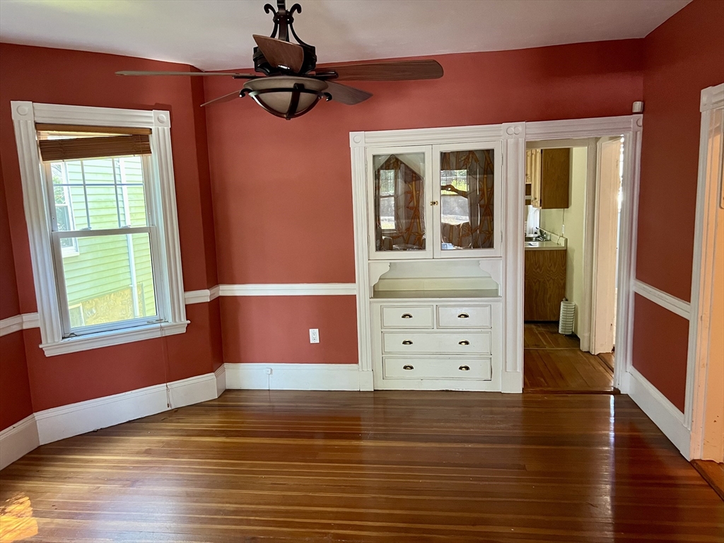 765 Boylston Street, Unit 1 Brookline, MA 02467 - Photo 12 of 12 a view of a livingroom with an empty space wooden floor and a window