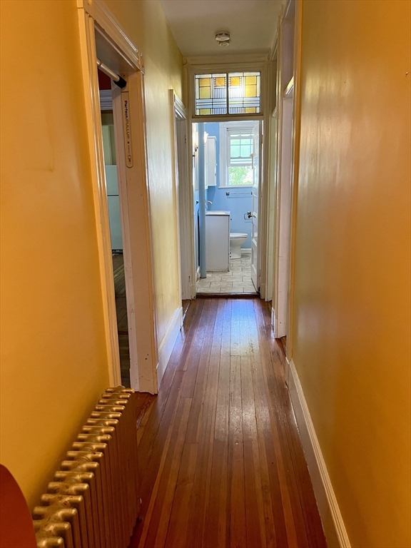 765 Boylston Street, Unit 1 Brookline, MA 02467 - Photo 5 of 12 a view of a room with wooden floor and a bathroom