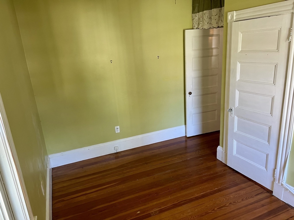 765 Boylston Street, Unit 1 Brookline, MA 02467 - Photo 6 of 12 a view of wooden floor and brick walls