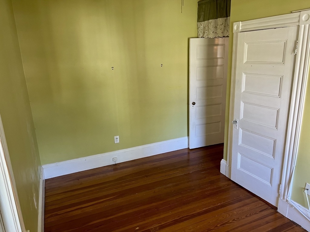 765 Boylston Street, Unit 1 Brookline, MA 02467 - Photo 8 of 12 a view of empty room with wooden floor