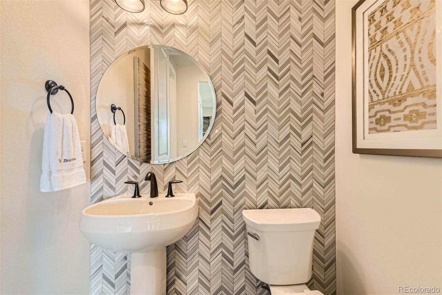 14163 Kearney Loop Thornton, CO 80602 - Photo 12 of 35 a bathroom with a toilet and a sink
