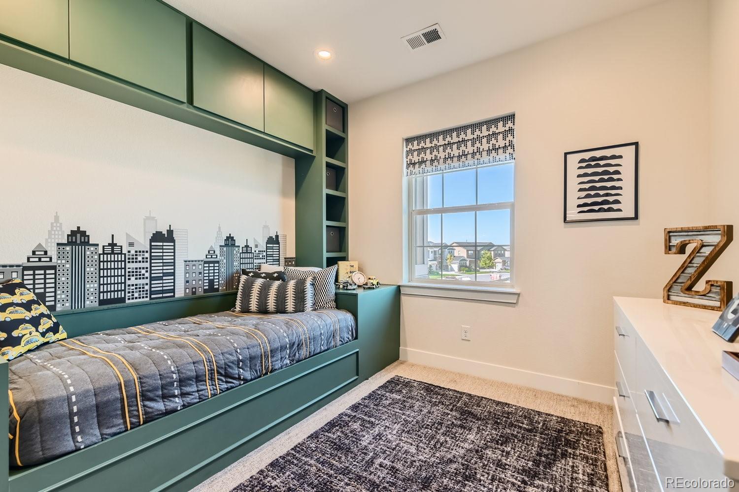 14163 Kearney Loop Thornton, CO 80602 - Photo 19 of 35 a bedroom with a bed and a window