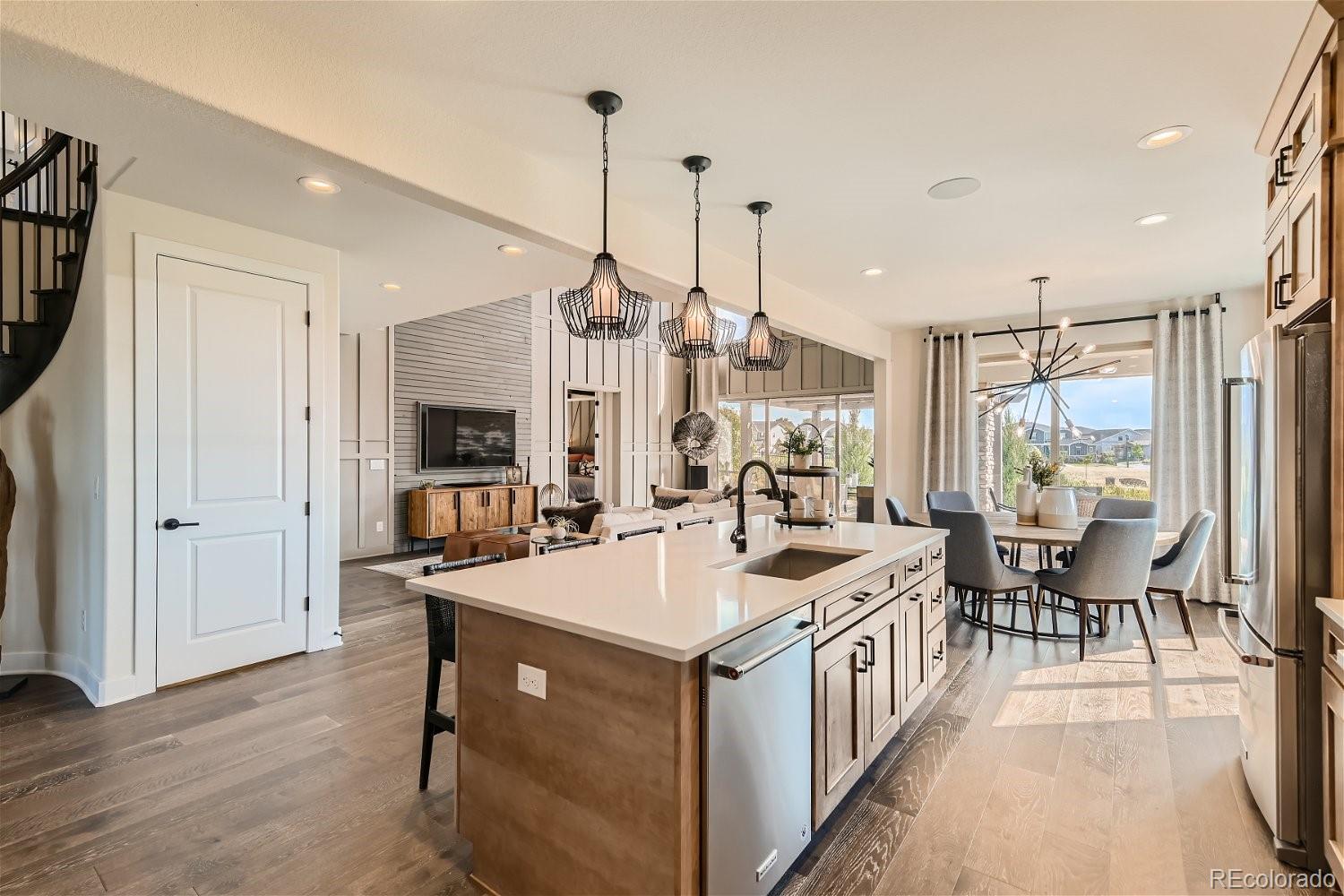 14163 Kearney Loop Thornton, CO 80602 - Photo 6 of 35 a kitchen with a sink stove and chairs