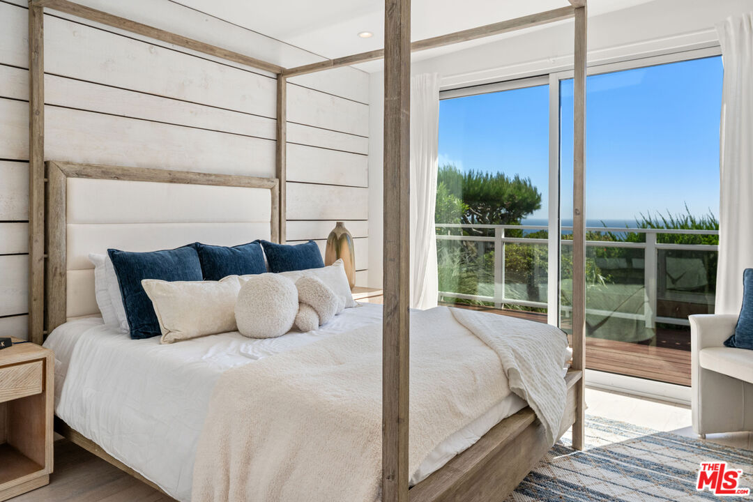 29500 Heathercliff Road, Unit 173 Malibu, CA 90265 - Photo 11 of 27 a bedroom with a large window and a balcony