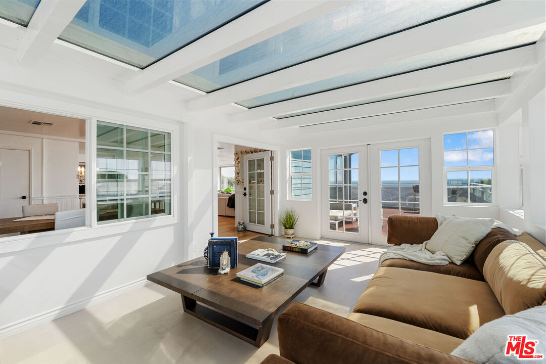 29500 Heathercliff Road, Unit 173 Malibu, CA 90265 - Photo 16 of 27 a living room with furniture and floor to ceiling windows