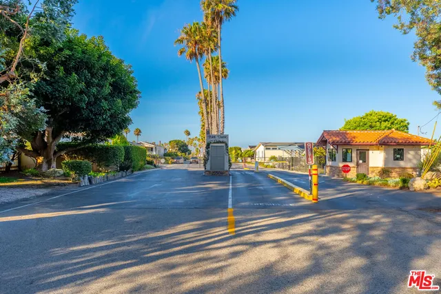 a view of a swimming pool with a lawn chairs under an umbrella