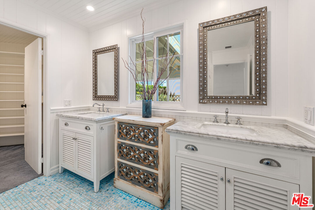 29500 Heathercliff Road, Unit 173 Malibu, CA 90265 - Photo 8 of 27 a bathroom with a sink a vanity and a mirror