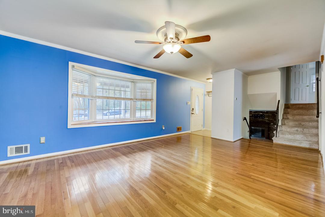 7215 Willow Oak Place Springfield, VA 22153 - Photo 13 of 30 a view of an empty room with wooden floor and a window