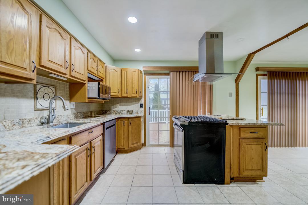 7215 Willow Oak Place Springfield, VA 22153 - Photo 15 of 30 a kitchen with stainless steel appliances granite countertop a sink and a stove