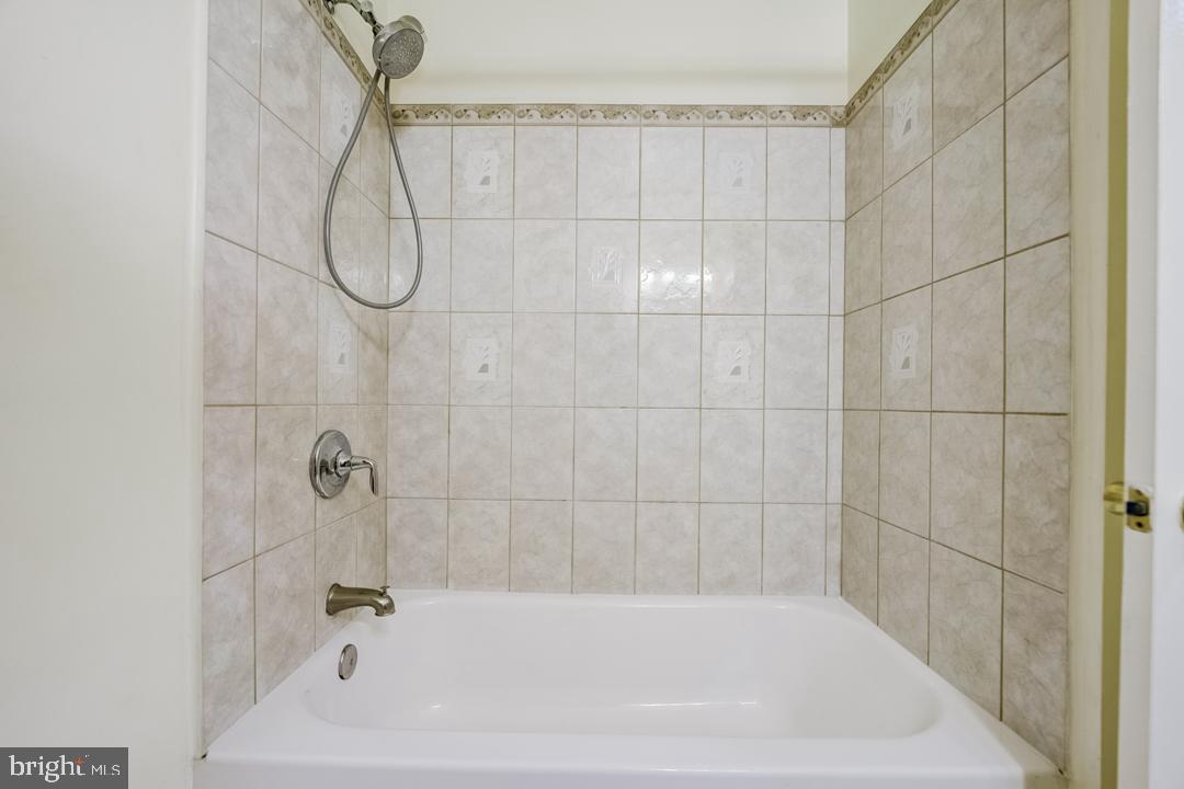 7215 Willow Oak Place Springfield, VA 22153 - Photo 26 of 30 a bathroom with a bath tub with a shower