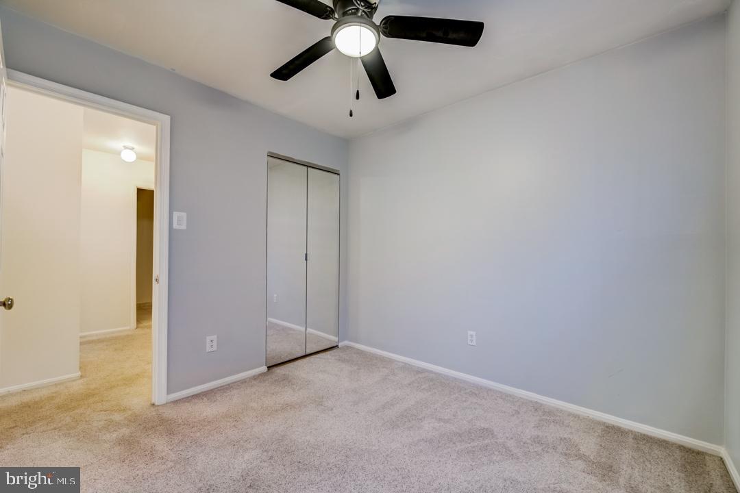 7215 Willow Oak Place Springfield, VA 22153 - Photo 30 of 30 an empty room with closet and a chandelier fan