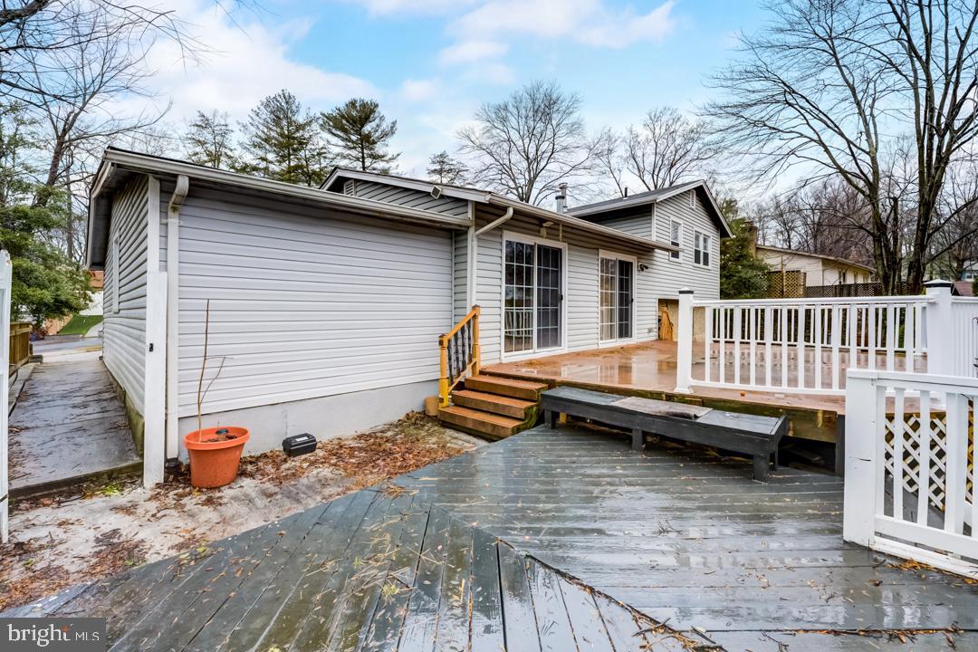 7215 Willow Oak Place Springfield, VA 22153 - Photo 5 of 30 a view of a house with a wooden deck and a floor to ceiling window
