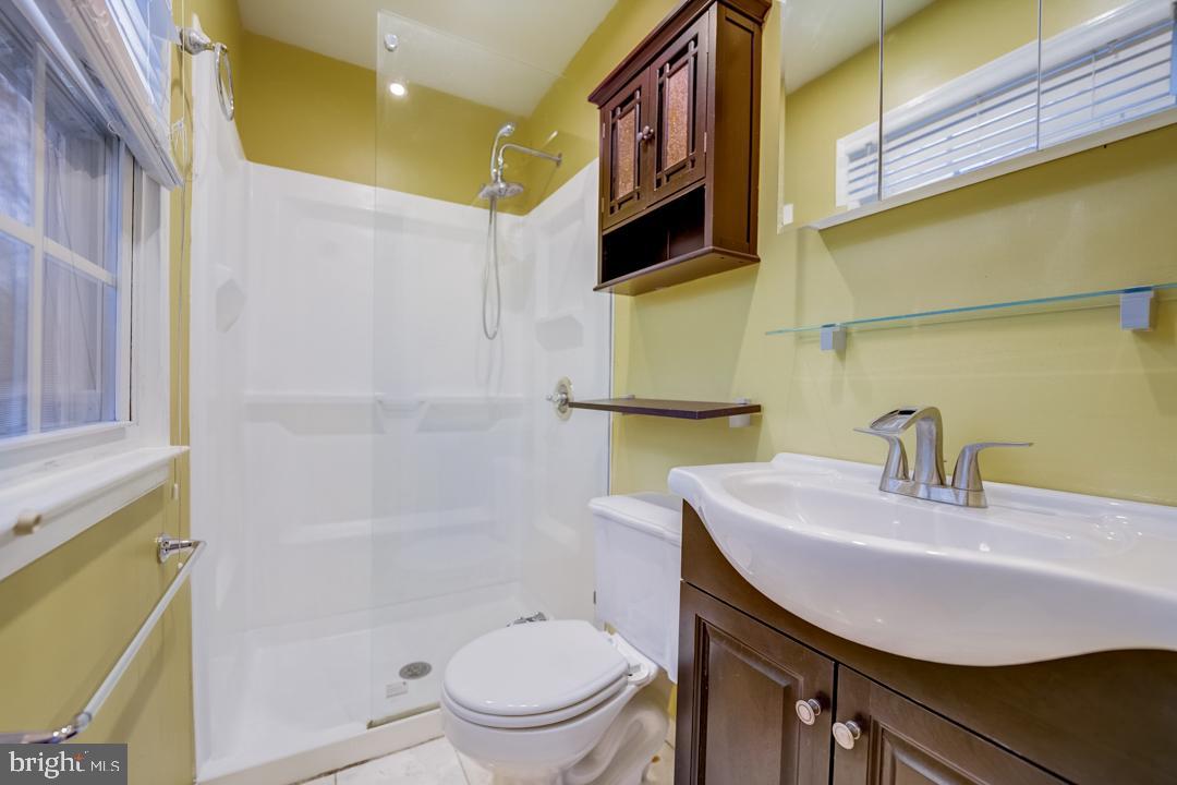 7215 Willow Oak Place Springfield, VA 22153 - Photo 9 of 30 a bathroom with a sink a toilet and shower