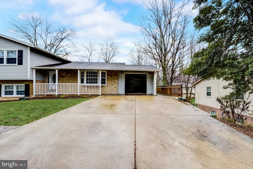 7215 Willow Oak Place Springfield, VA 22153 - Photo 10 of 30 a front view of a house with a garden and trees