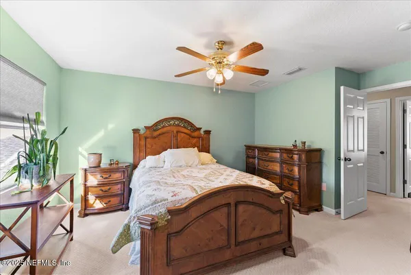 a bedroom with a bed chair and a window