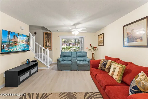 a living room with furniture and a flat screen tv