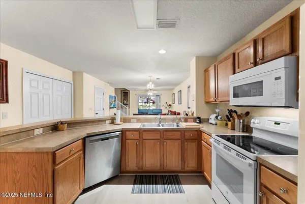 a kitchen with a sink stove and cabinets