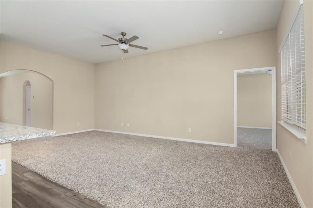 248 Enchanted Way Princeton, TX 75407 - Photo 9 of 24 an empty room with a ceiling fan and a window