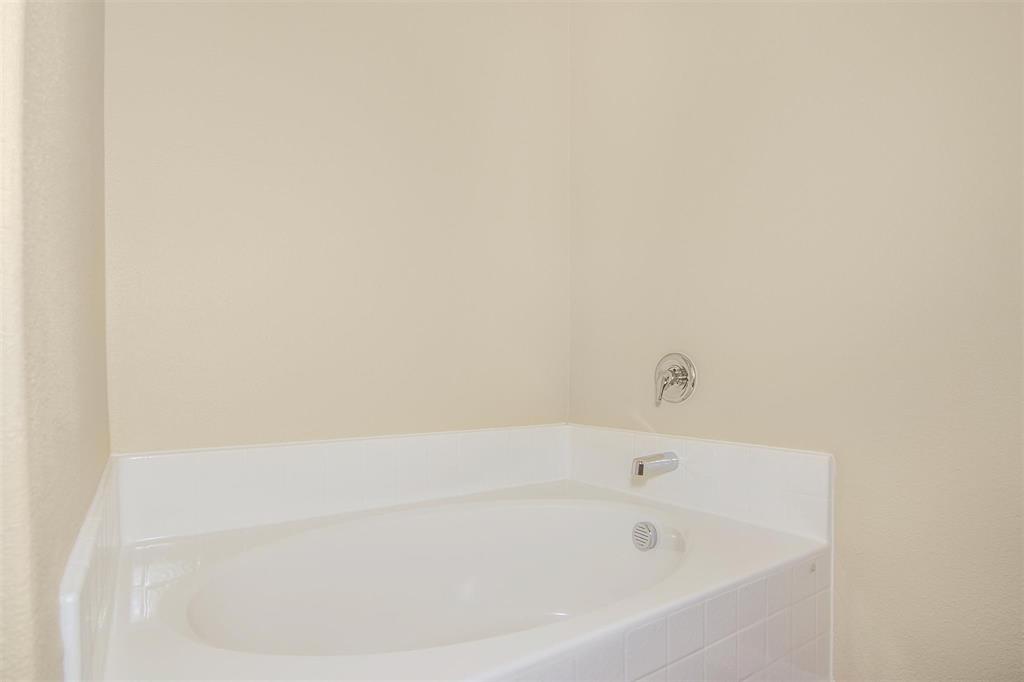 248 Enchanted Way Princeton, TX 75407 - Photo 19 of 24 a white bath tub sitting in a bathroom