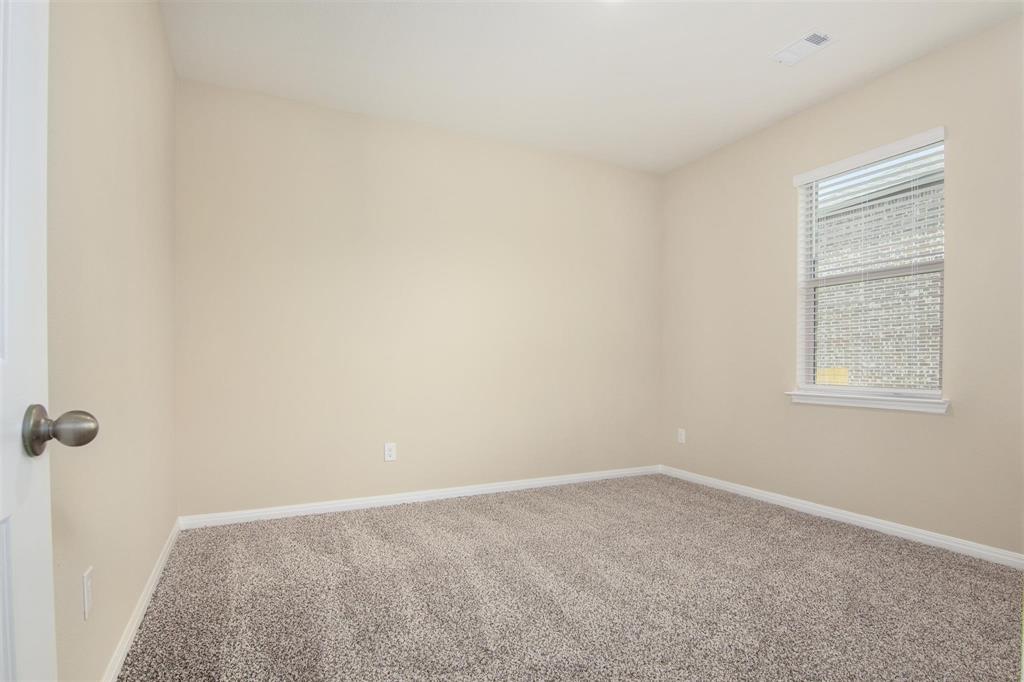 248 Enchanted Way Princeton, TX 75407 - Photo 20 of 24 an empty room with windows