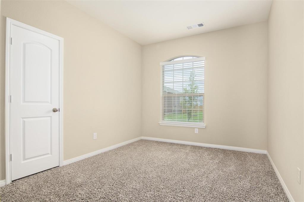 248 Enchanted Way Princeton, TX 75407 - Photo 21 of 24 an empty room with windows