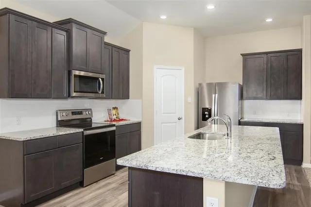 a kitchen with a refrigerator and cabinets
