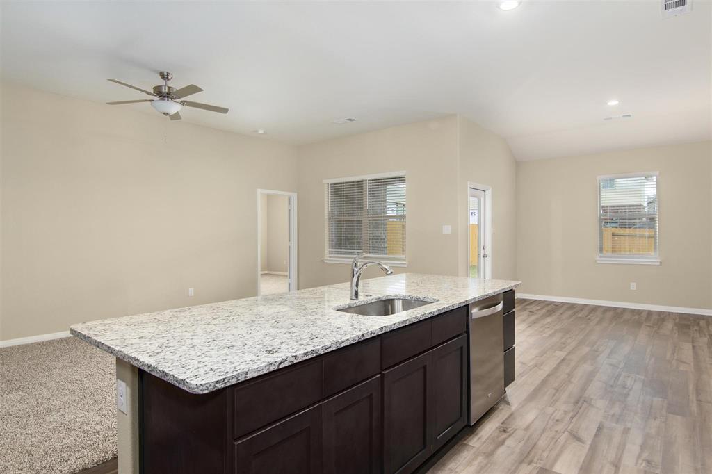 248 Enchanted Way Princeton, TX 75407 - Photo 23 of 24 a bathroom with a granite countertop sink and a mirror