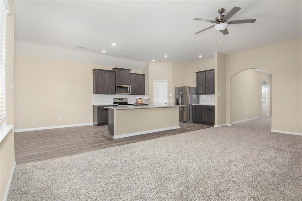 248 Enchanted Way Princeton, TX 75407 - Photo 24 of 24 a large kitchen with cabinets and stainless steel appliances