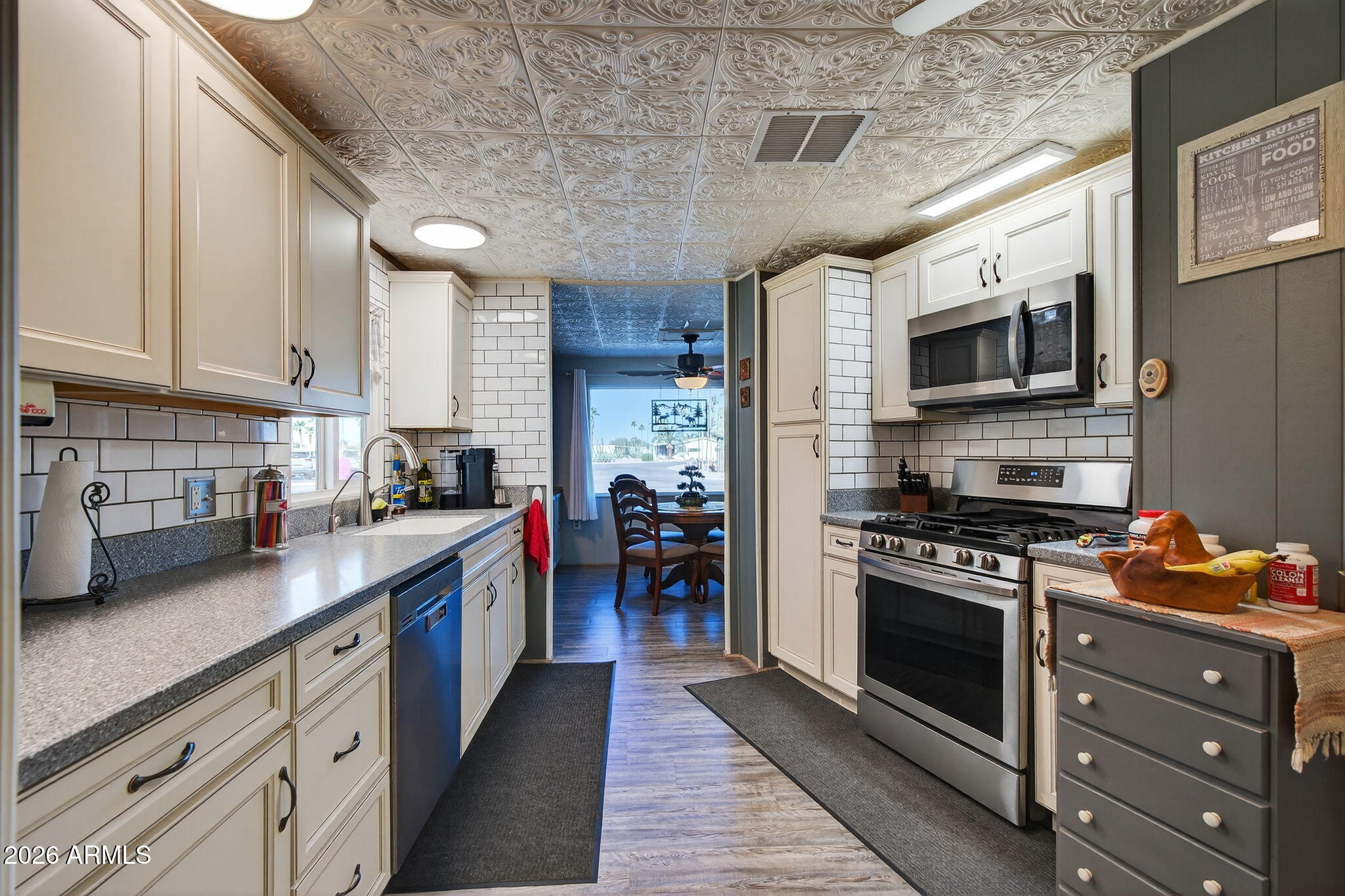 2100 North Trekell Road, Unit 196 Casa Grande, AZ 85122 - Photo 11 of 40 a kitchen with stainless steel appliances granite countertop a stove sink microwave and cabinets