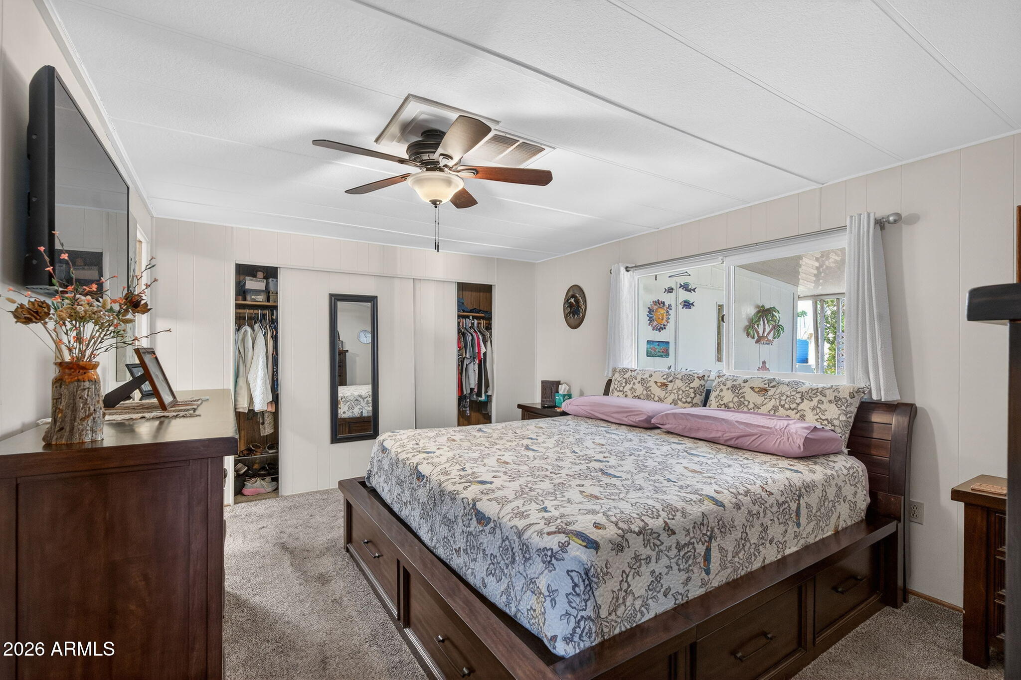 2100 North Trekell Road, Unit 196 Casa Grande, AZ 85122 - Photo 18 of 40 a bedroom with a bed a dresser and potted plants
