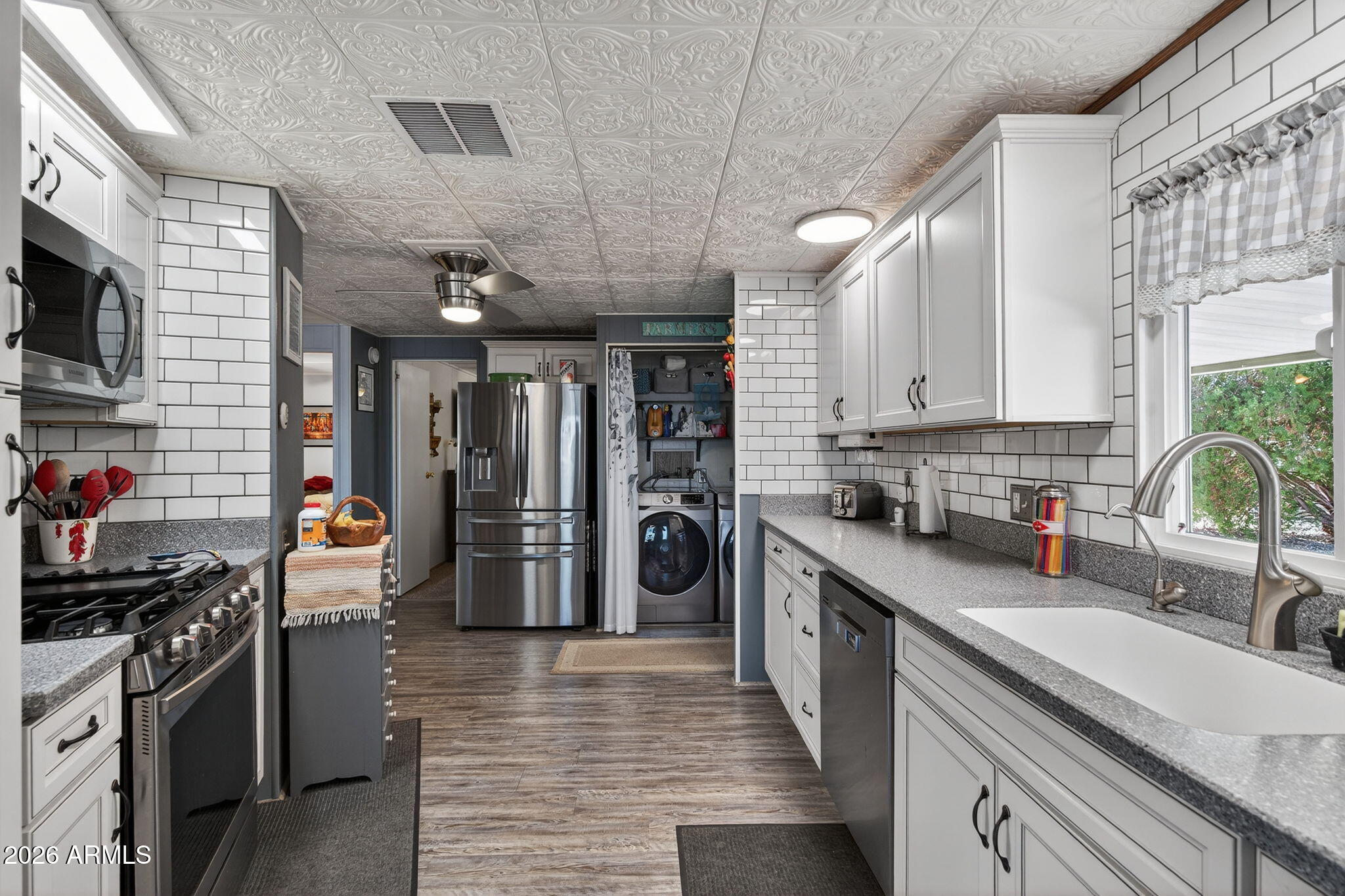 2100 North Trekell Road, Unit 196 Casa Grande, AZ 85122 - Photo 10 of 40 a kitchen with stainless steel appliances granite countertop a refrigerator a stove and a sink