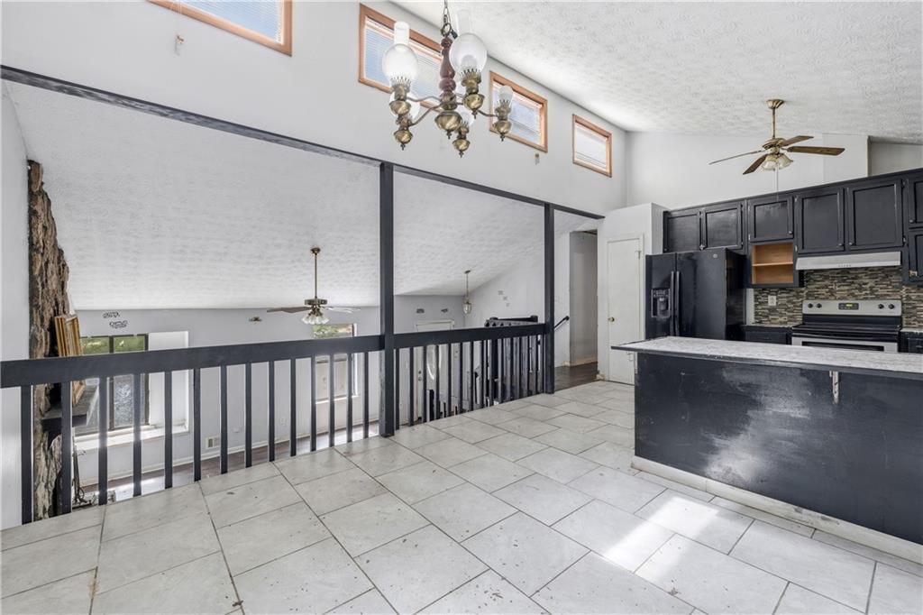 40 Judy Court Stockbridge, GA 30281 - Photo 12 of 20 a view of a kitchen with kitchen island granite countertop a refrigerator a sink and a stove
