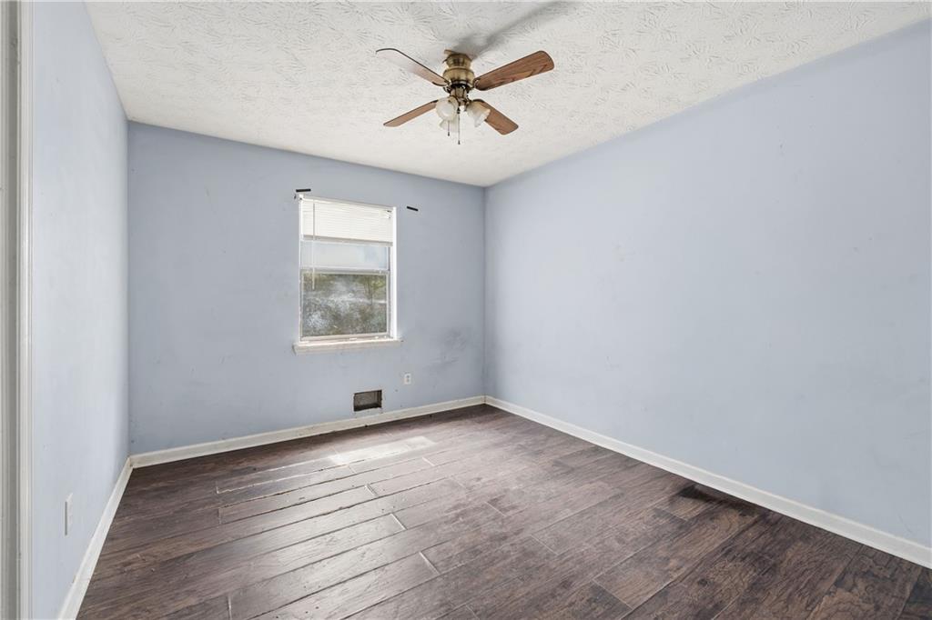 40 Judy Court Stockbridge, GA 30281 - Photo 14 of 20 an empty room with wooden floor and windows