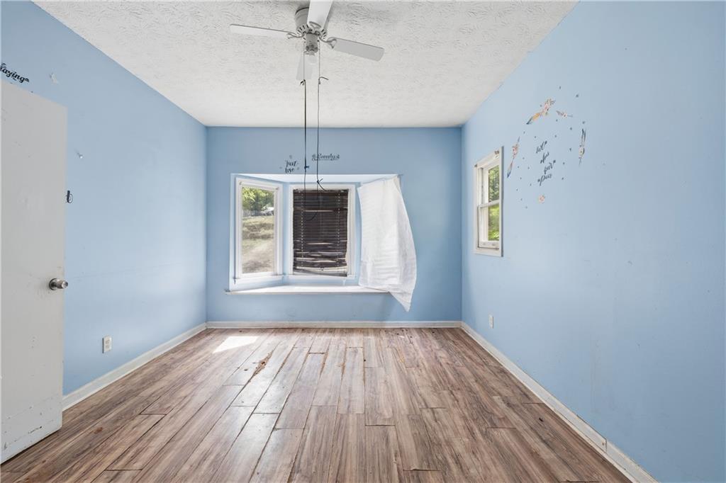 40 Judy Court Stockbridge, GA 30281 - Photo 4 of 20 a view of an empty room with a window and wooden floor