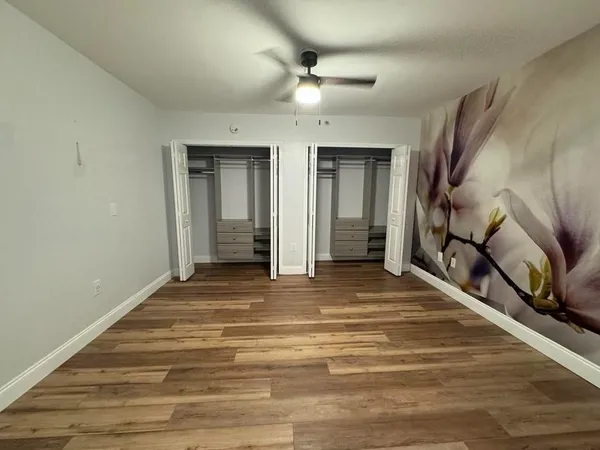 a view of an entryway with wooden floor