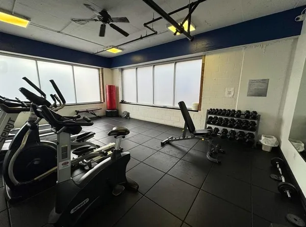 a room with gym equipment and a large window