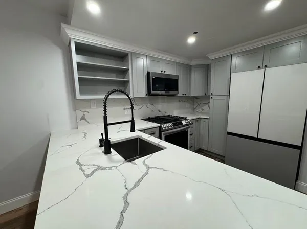 a kitchen with a refrigerator stove and a sink