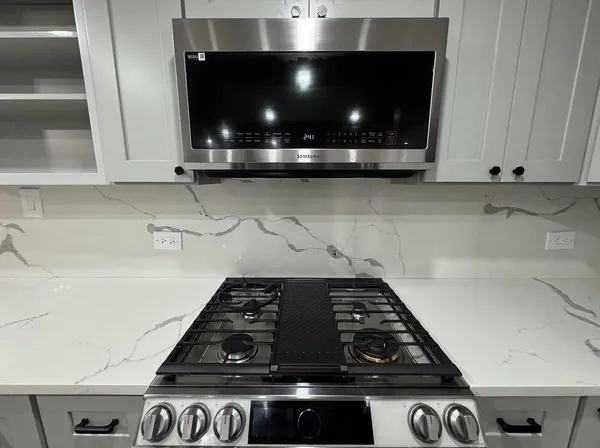 a stove sitting inside of a kitchen