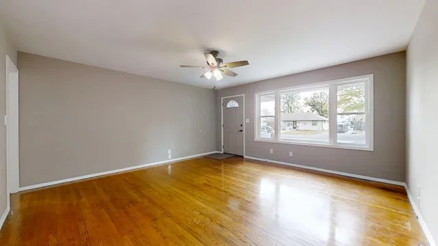 a view of an empty room with a window