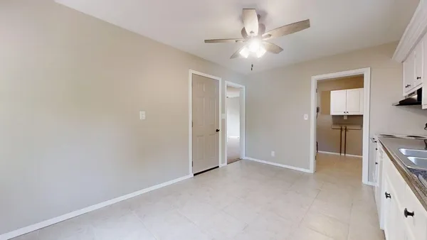 a view of a kitchen with a sink and a refrigerator