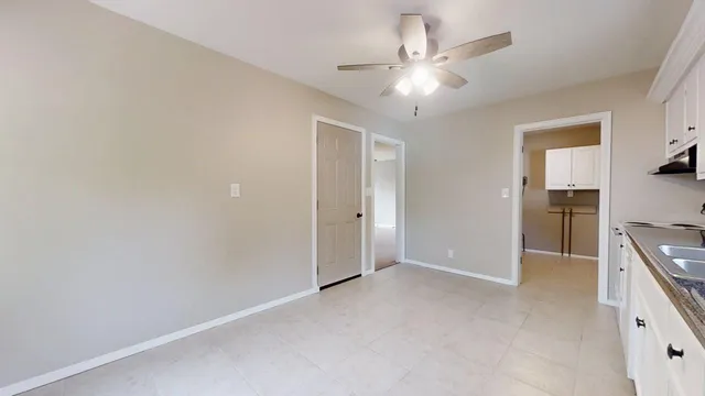 a view of a kitchen with a sink and a refrigerator