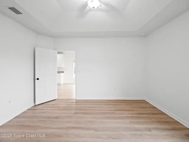 a view of an empty room and wooden floor