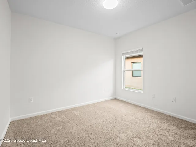 a view of an empty room and a window