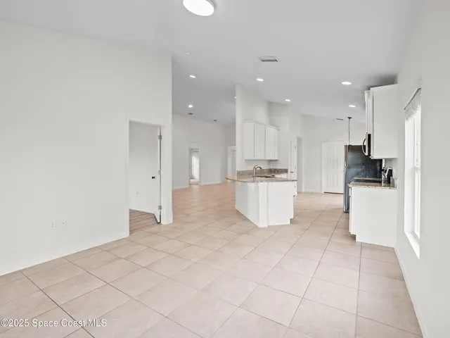 a view of kitchen with white cabinets