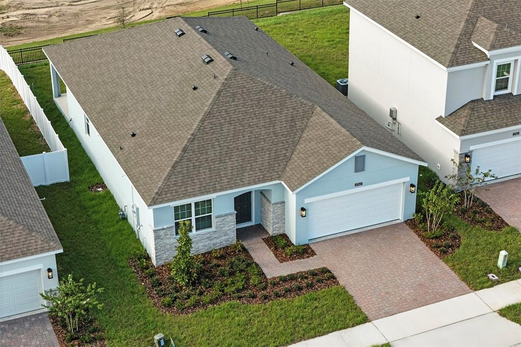 27517 Stellar Sea Way Howey-in-the-Hills, FL 34737 - Photo 2 of 17 a aerial view of a house with a yard