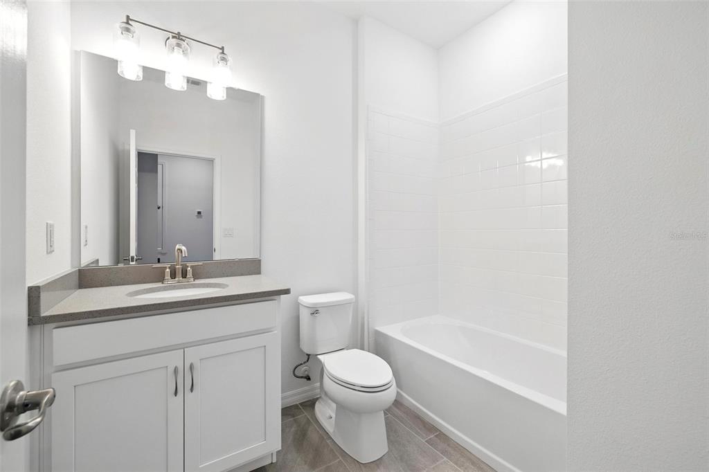 27517 Stellar Sea Way Howey-in-the-Hills, FL 34737 - Photo 7 of 17 a bathroom with a sink a toilet and shower