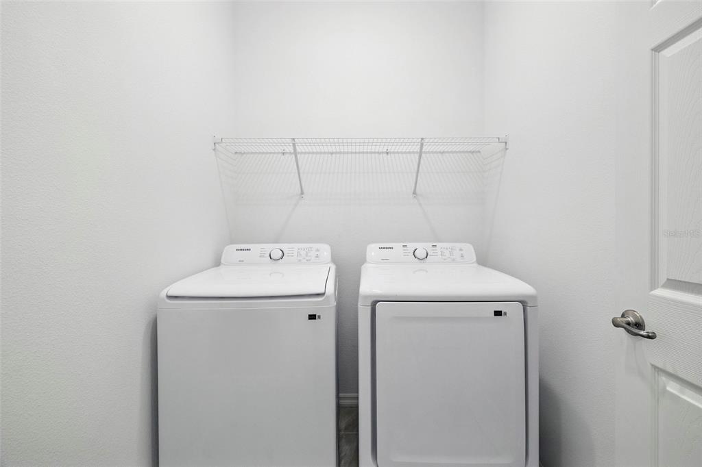 27517 Stellar Sea Way Howey-in-the-Hills, FL 34737 - Photo 8 of 17 a utility room with dryer and washer