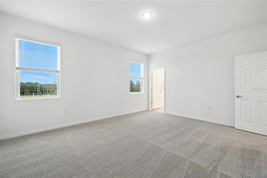 27517 Stellar Sea Way Howey-in-the-Hills, FL 34737 - Photo 10 of 17 an empty room with a window