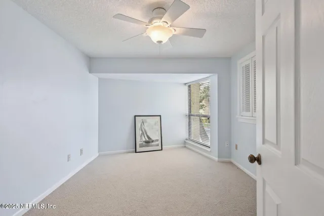 a bathroom with a toilet a sink a mirror and shower