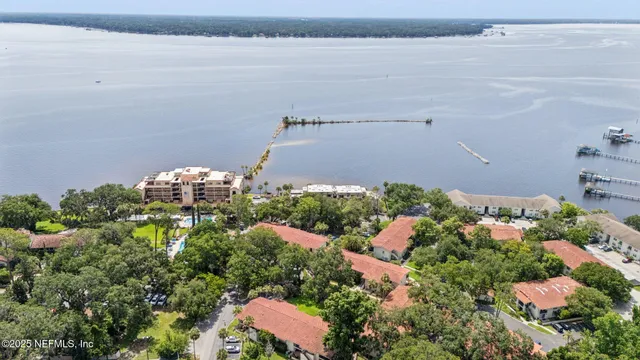 an aerial view of a house with a lake view